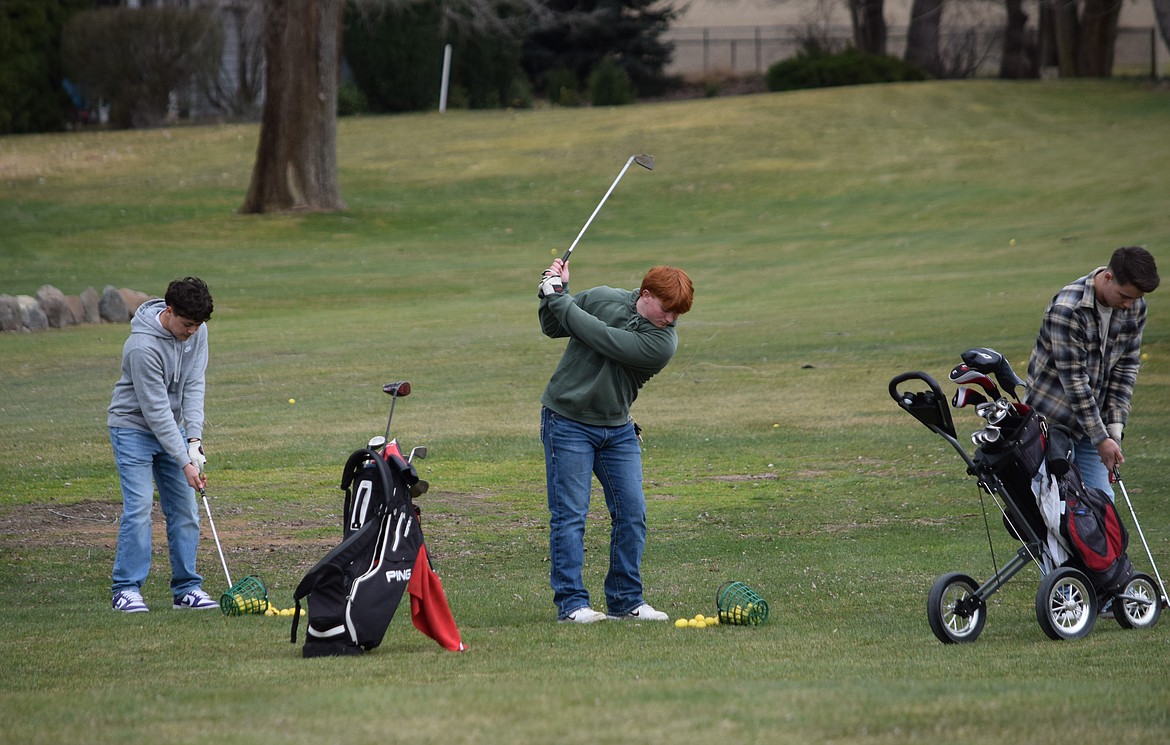 Varsity and Junior Varsity Othello Boys Golf players practice at the Othello Golf Club’s driving range Monday.