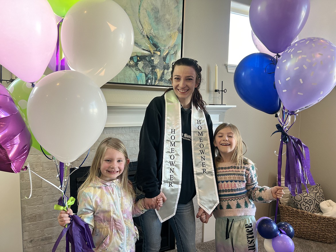 Xena Reeser, Sarah Reeser and Freja Reeser hold balloons after finding out they've been selected for the First Story home in Rathdrum.