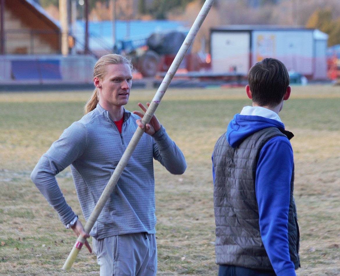 (left) Nik Bertling, BFHS pole vaulting coach and All-American, teaches a Badger pole vaulter proper technique to hold the pole.