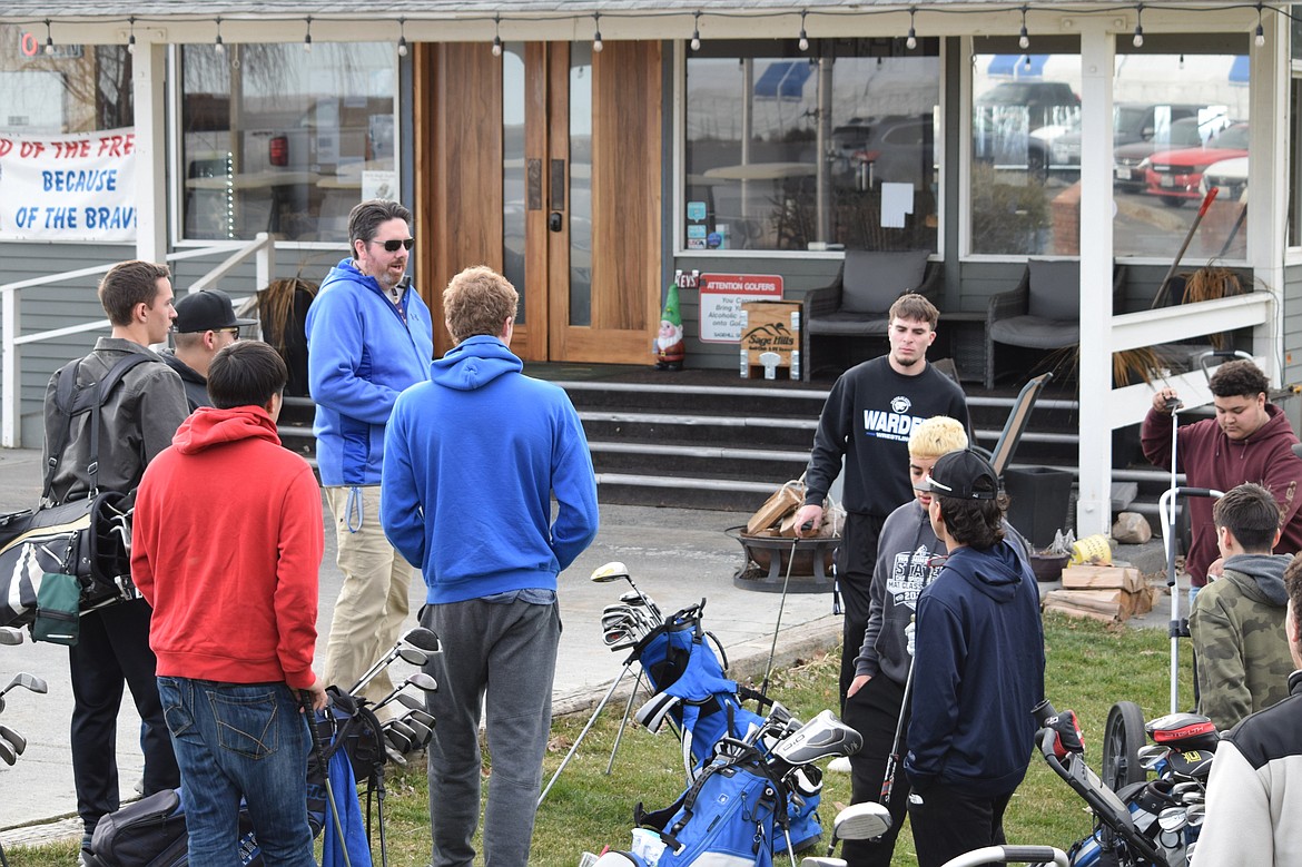 Warden Boys Golf Head Coach Tim Carlberg, back left, faces the Warden Boys Golf team at the beginning of their practice at Sage Hills Golf Club Friday before splitting the team up into groups to play on different holes of the course.