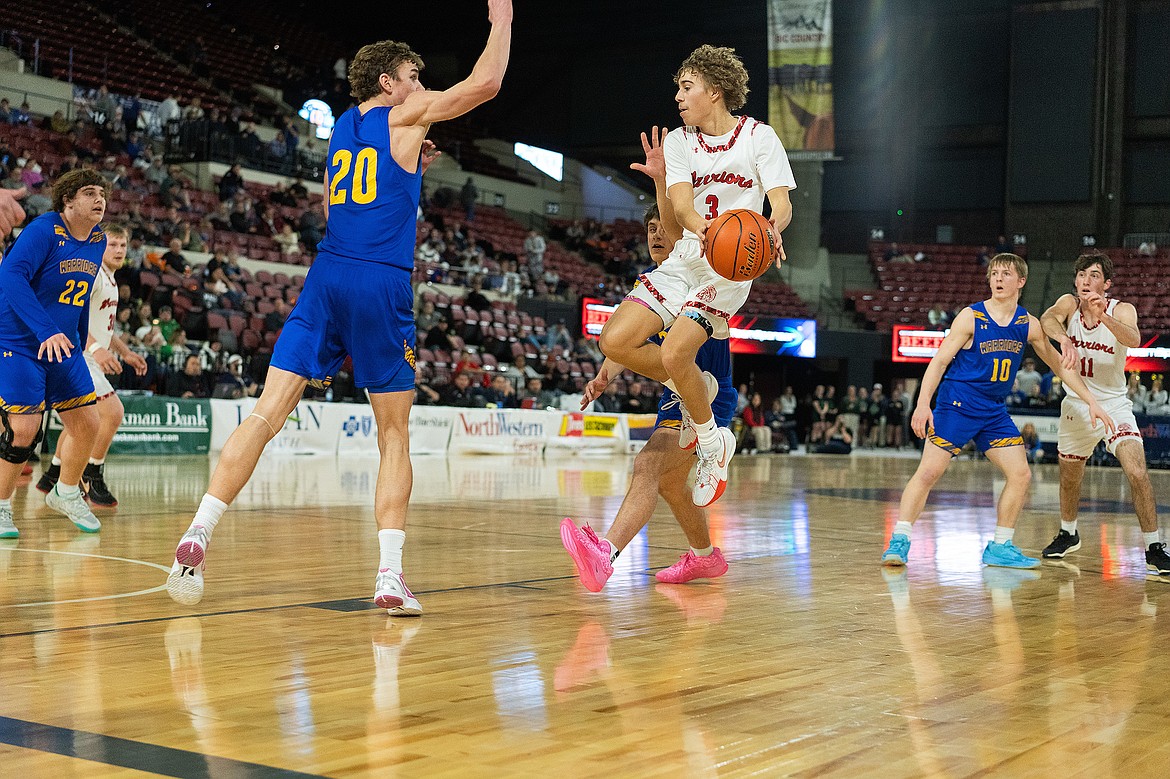 Arlee's Ethan Fiddler (3) drives against Fairview's Jeff Tjelde (20) during the Boys Class B State High School Basketball Championships on Thursday, March 7, in Billings. Fairview defeated Arlee in the first round of the tournament, but the Warriors went on to place fourth. (Kenneth Jarecke/The Curious Society)