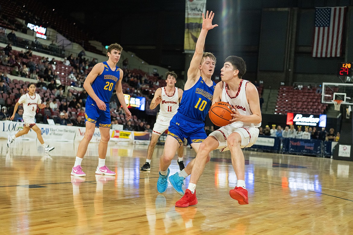 Two sets of Warriors – Arlee and Fairview – battle it out during the first round of the Boys Class B State High School Basketball Championships on  March 7 in Billings. (Kenneth Jarecke/The Curious Society