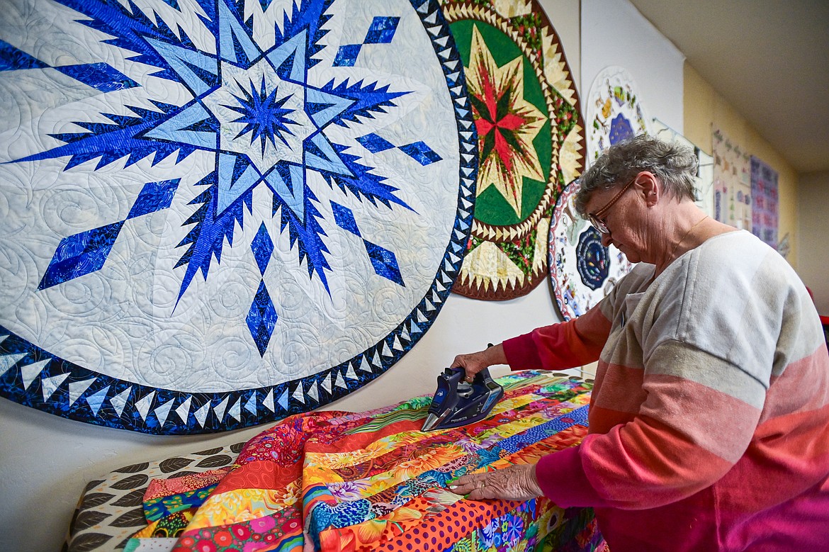 Linda Anderson irons the quilt titled "Mile a Minute" during a Flathead Quilters' Guild sewing day at the Quilt Gallery in Kalispell on Wednesday, March 13. (Casey Kreider/Daily Inter Lake)