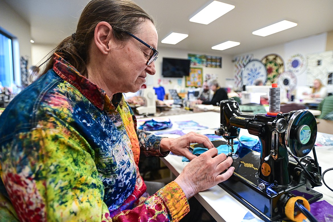 Cathy Calloway, a member of the Flathead Quilters' Guild, stitches together individual quilt blocks on her Singer Featherweight sewing machine from the 1930s during one of the Guild's sewing days at the Quilt Gallery in Kalispell on Wednesday, March 13. (Casey Kreider/Daily Inter Lake)