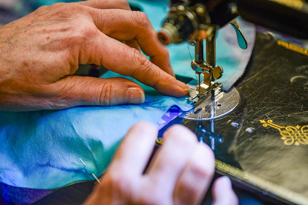 Cathy Calloway, a member of the Flathead Quilters' Guild, stitches together individual quilt blocks on her Singer Featherweight sewing machine from the 1930s during one of the Guild's sewing days at the Quilt Gallery in Kalispell on Wednesday, March 13. (Casey Kreider/Daily Inter Lake)