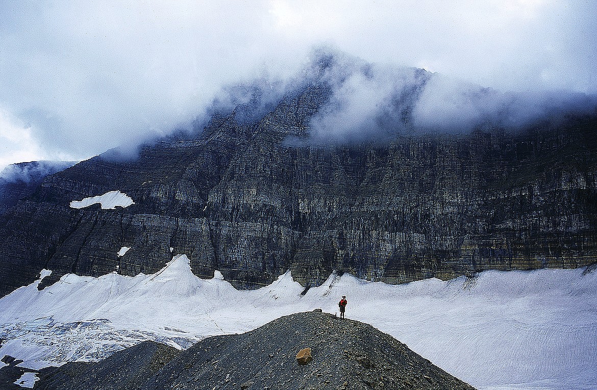 A visitor looks over Sexton Glacier in Glacier National Park. A study by the U.S. Geological Survey last fall found that 11 glaciers in Glacier National Park have broken into pieces, as climate change continues to warm the planet and the park.