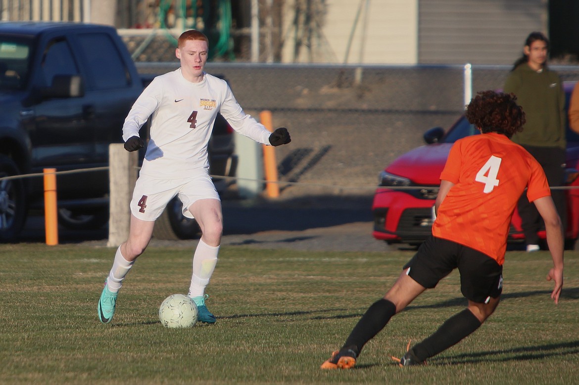 Moses Lake sophomore Kyre Wiltbank, in white, looks to pass the ball to a teammate in the first half of Tuesday’s game against Ephrata.