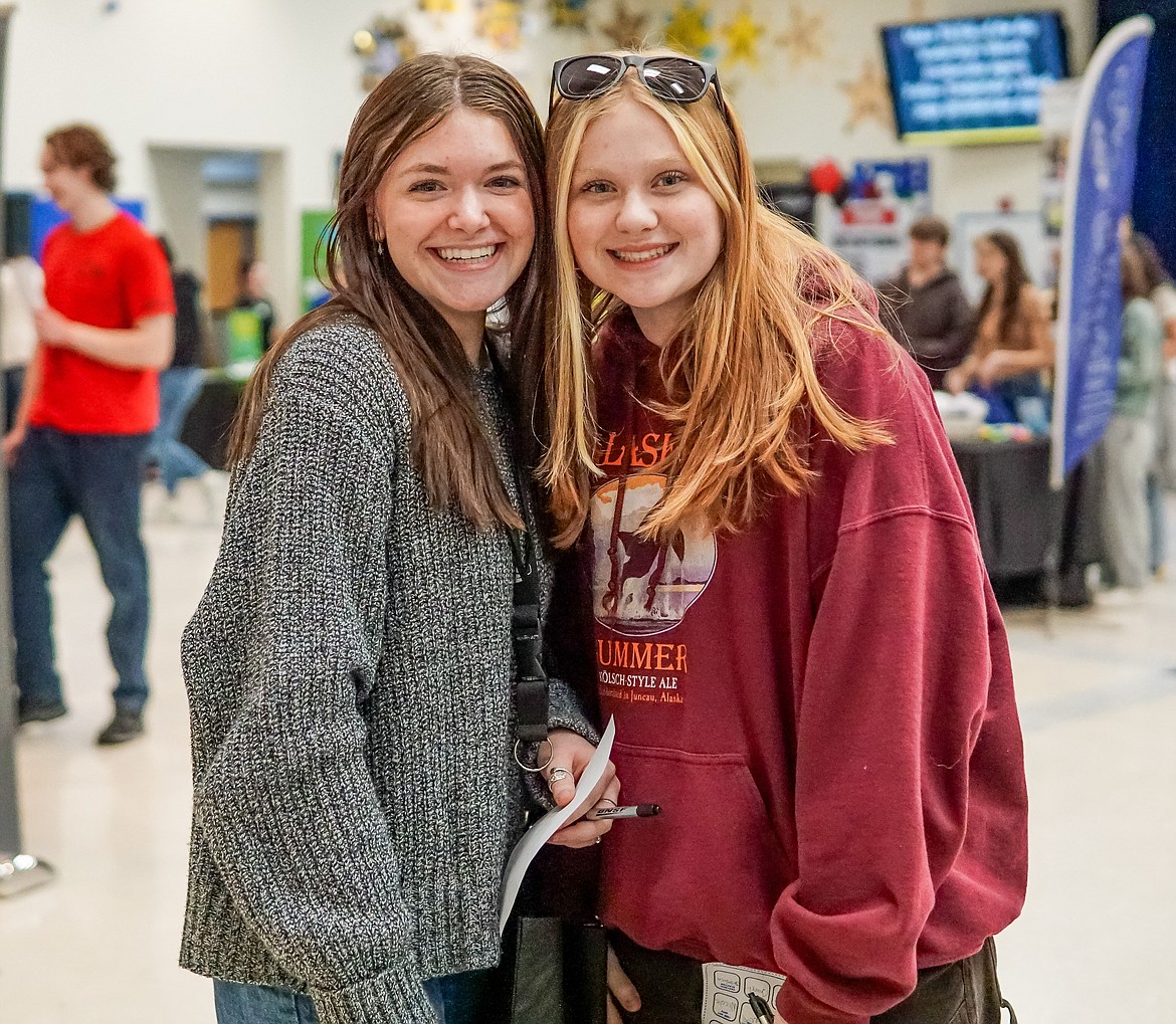 Payton Ranney, left, stands with Sydney Lauer after visiting all of the tables at the "Opportunity Knocks" job fair at Timberland High School on Wednesday.