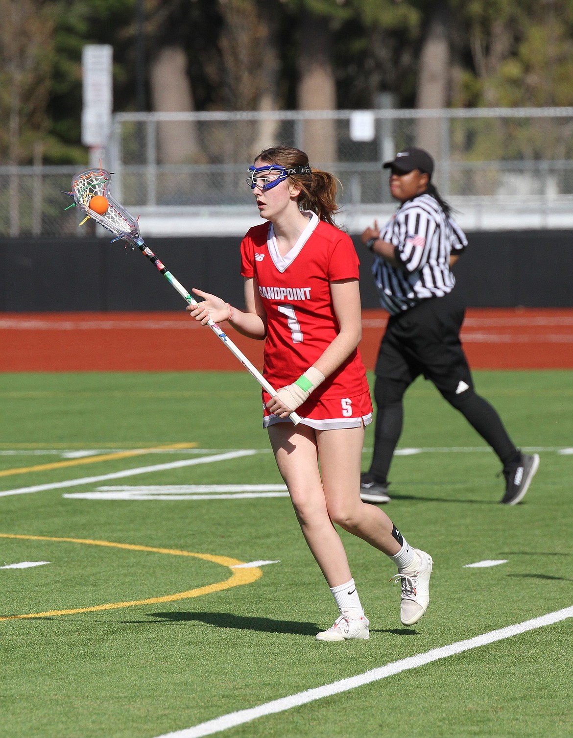 Sandpoint's Cassidy Aitken looks to pass to a teammate in a game held at War Memorial Field last season.