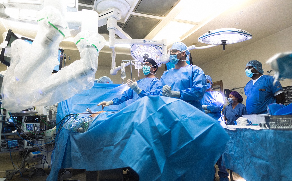 Samaritan Healthcare surgeon Jordan Smith, background center, operates the hospital’s da Vinci surgical robot during a procedure. Surgeons began using the robot in November 2023.