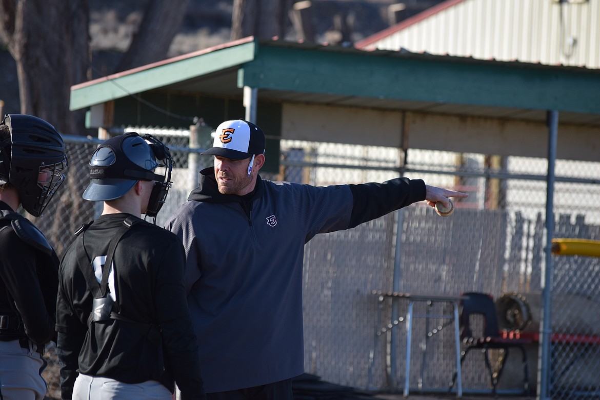 Tiger Head Baseball Coach David Tempel talks with his catching crew on Tuesday. Tempel said he’s impressed with how the catchers and pitchers have worked to ensure they have solid strategies in place.