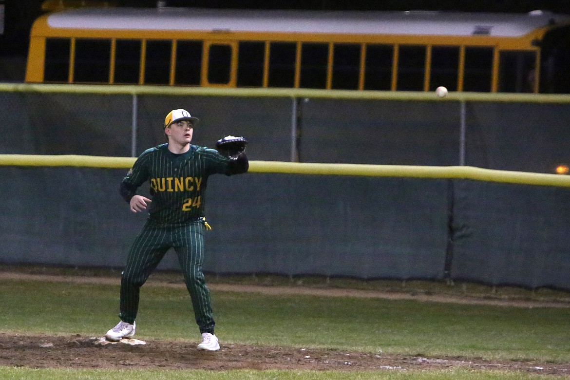 Quincy junior DJ Frerks catches the ball while standing on first base for an out during a game against Ephrata.