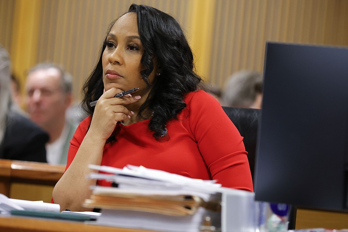 Fulton County District Attorney Fani Willis looks on during a hearing on the Georgia election interference case, Friday, March, 1, 2024, in Atlanta. A progressive Democrat and a Republican who briefly worked in Donald Trump's administration entered the Fulton County district attorney's race Friday, March 8, 2024, as the current officeholder, Willis, awaits a judge's decision on whether she will be removed from the Georgia election interference case against the former president. (AP Photo/Alex Slitz, Pool, File)