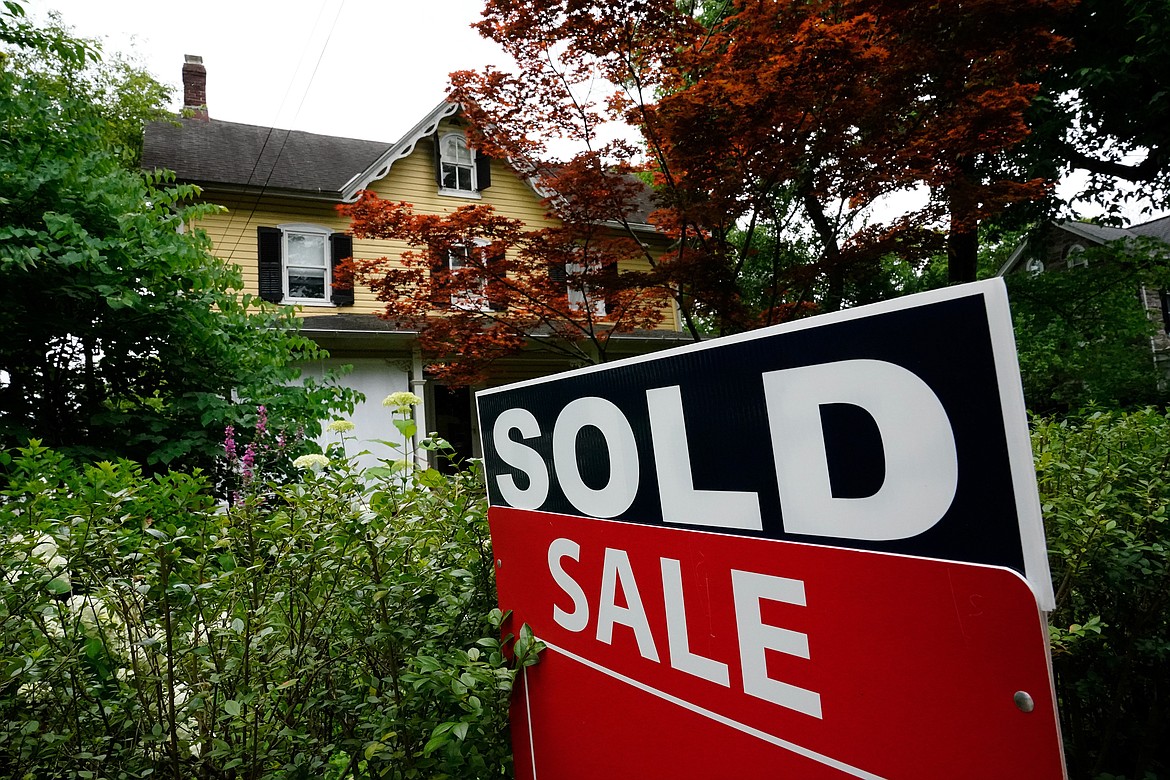 FILE - A sale sign stands outside a home in Wyndmoor, Pa., Wednesday, June 22, 2022. The National Association of Realtors has agreed on Friday, March 15, 2024, to pay $418 million and change its rules to settle lawsuits claiming homeowners have been unfairly forced to pay artificially inflated agent commissions when they sold their home. (AP Photo/Matt Rourke, File)