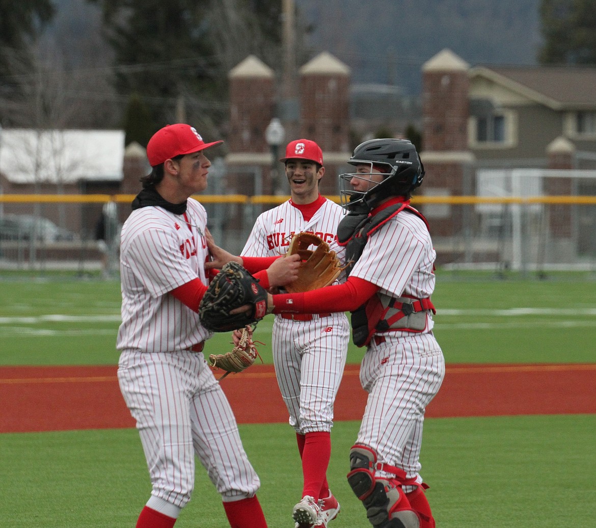 From left, Sandpoint's Jesse Turner, Drew Lehman, and Jorden Tyler celebrate after a win last season. All three players return to the diamond for the Bulldogs in 2024.