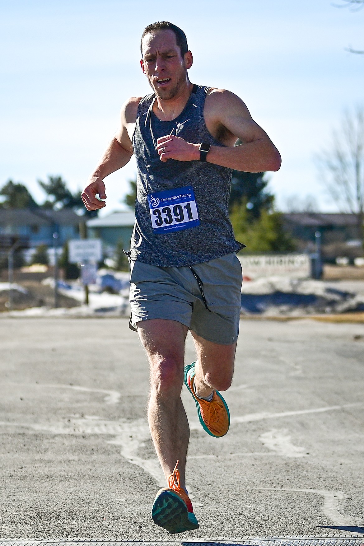 Brad Dolesh crosses the finish line in first place in the 5K run at Cloverfest in Columbia Falls on Saturday, March 16. (Casey Kreider/Daily Inter Lake)