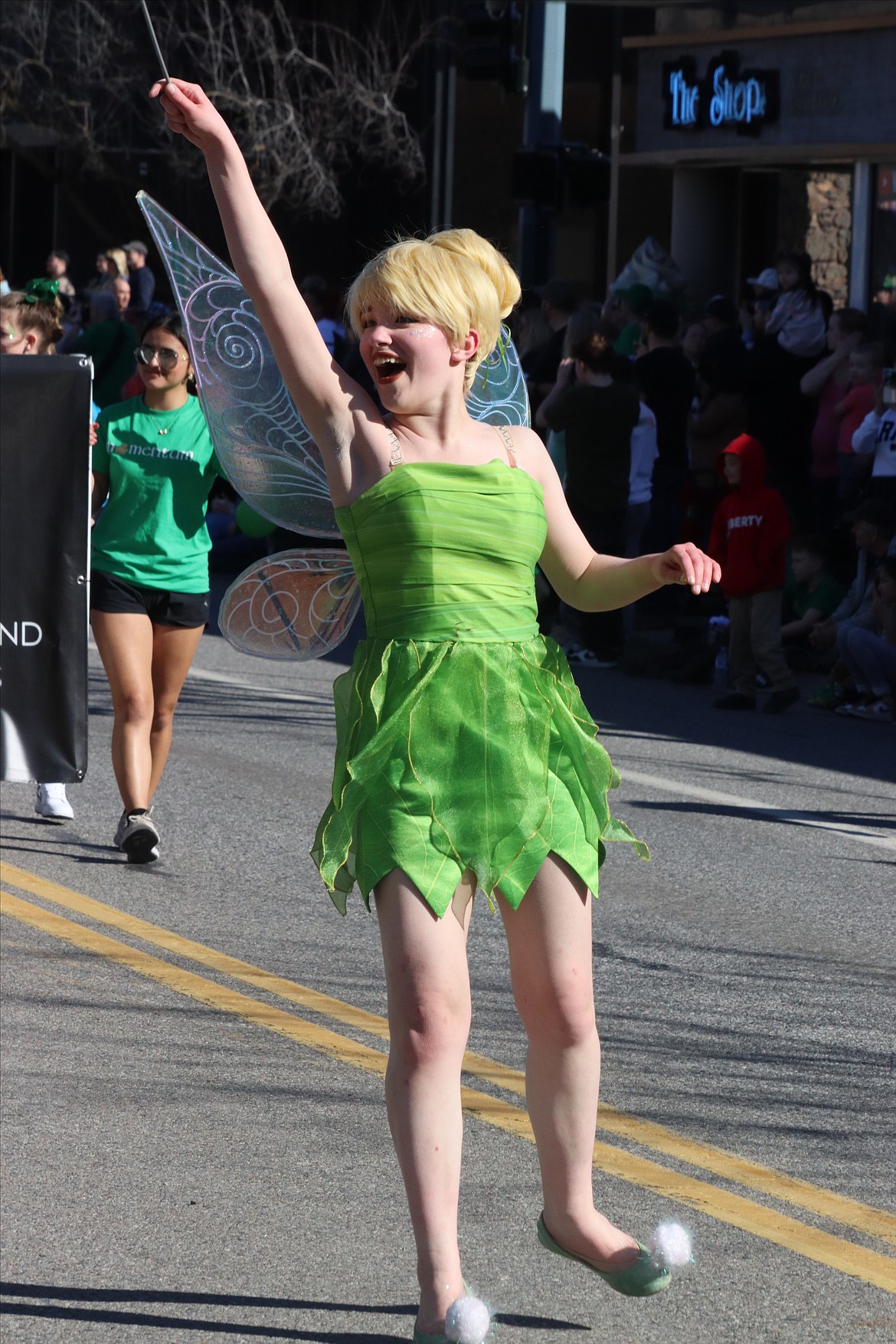 Tinkerbell waves her magic wand during the St. Patrick's Day Parade on Saturday.