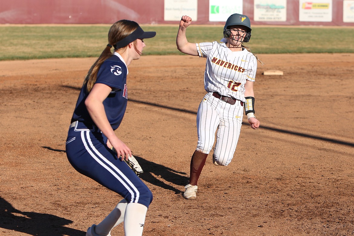 Moses Lake senior Trinity Nations, right, starts her slide into third base during Friday’s game against Mt. Spokane.