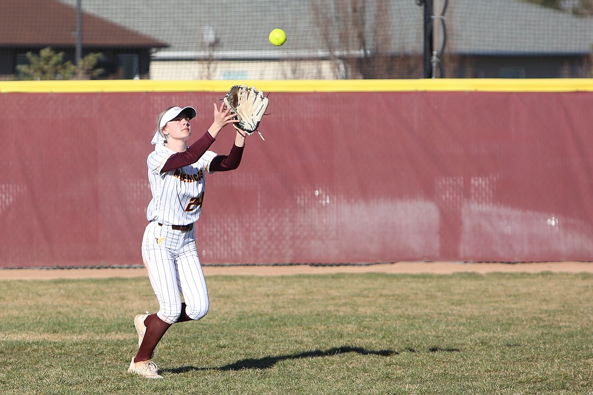 Moses Lake senior Kendall Reffett catches a fly ball in the outfield for an out.