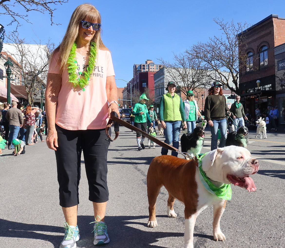 Lisa Houston and her English bulldog Obi-Wan Kenobi walk the St. Patrick's Day Parade.