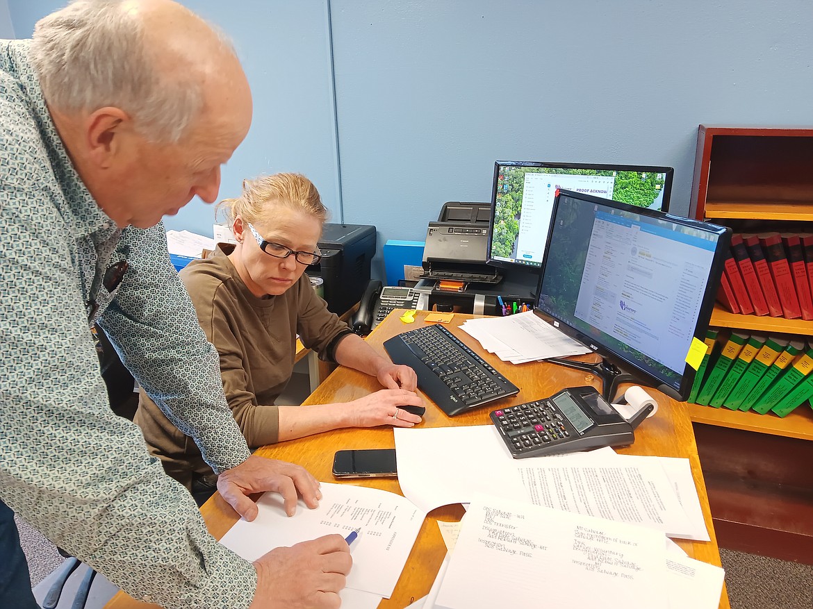 Mineral County Deputy County Attorney Wally Congdon and Treasurer Merry Mueller study the rulings of the Montana Supreme Court on the ruling of the Supreme Court on property taxes. Supplemental tax bills will be mailed out at the end of March. (Monte Turner/Mineral Independent)