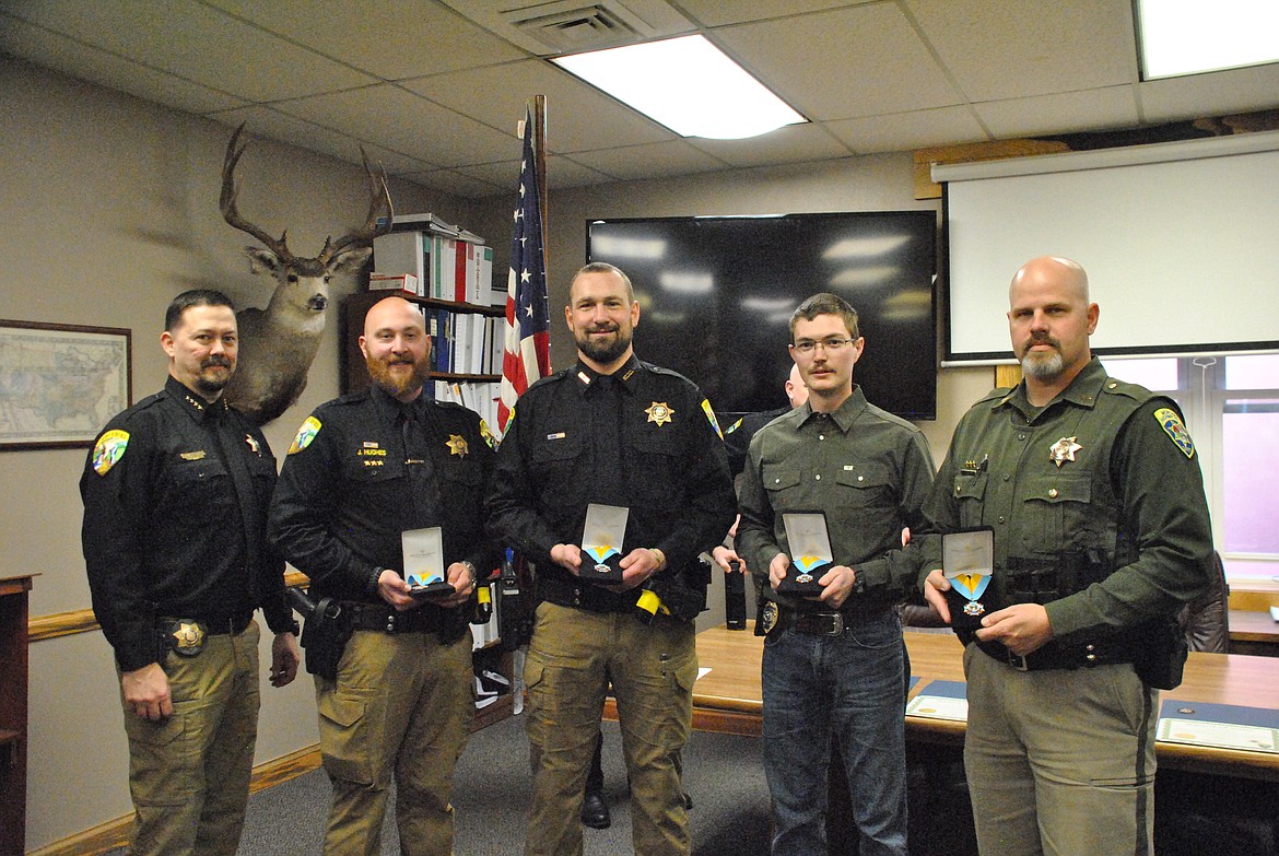 Sheriff Ryan Funke awarded the Medal of Valor to each officer for their heroic actions during a shooting that took place in St. Regis last March. Officer Jack Hughes, Eric Lindauer, former deputy Nick Wolter, and on behalf of the Montana Highway Patrol for Tom Tofoya, Sargent Shawn Smalley. (Mineral Independent/Amy Quinlivan)