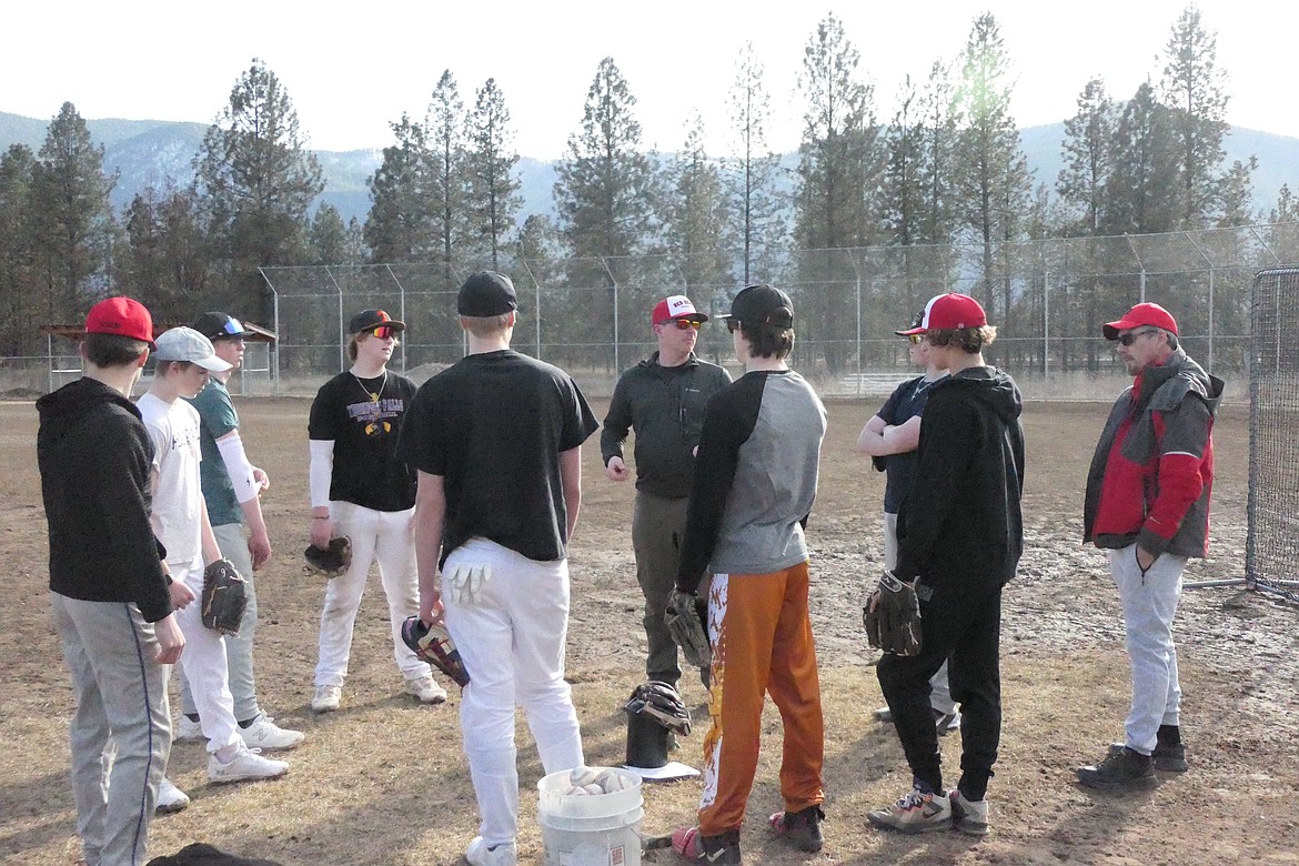 A pre-practice session with the coaches begins a practice at the T Falls baseball field last week on a sun splashed day. (Chuck Bandel/VP-MI)