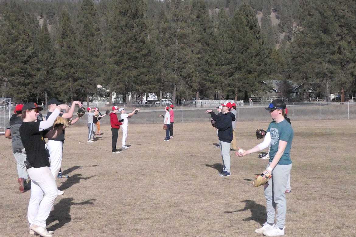 Players from the Noxon-Thompson Falls co-op high school baseball team loosening their throwing arms during a practice opening drill this past week in T Falls. (Chuck Bandel/VP-MI)