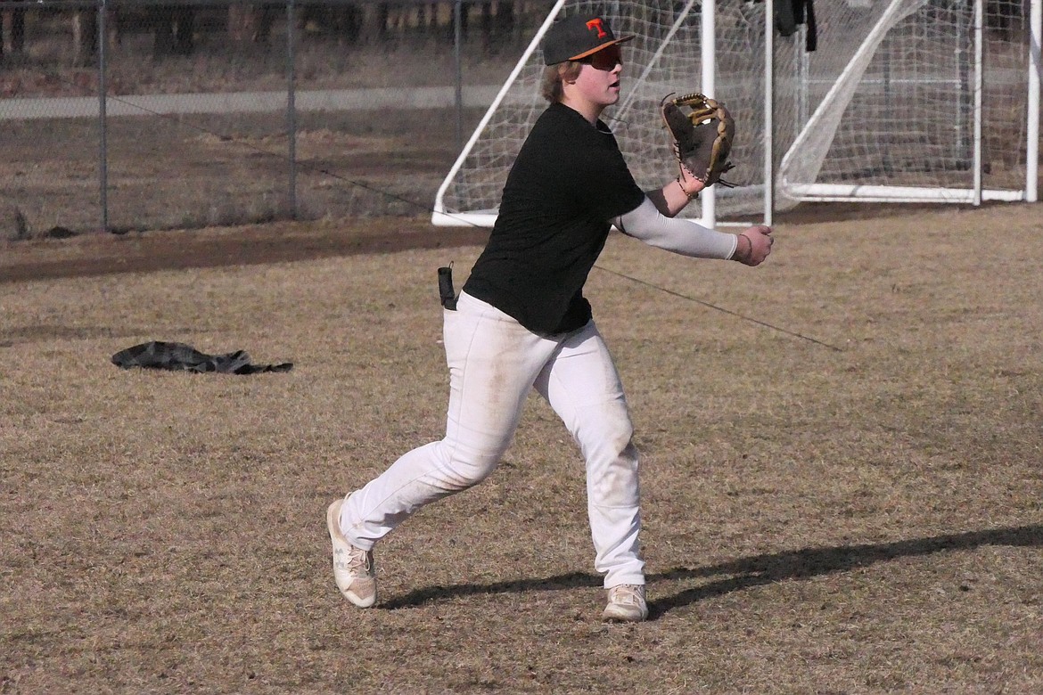 Thompson Falls student Bryson McCormick works out during a throwing drill at the baseball field adjacent to Thompson Falls High.  The new team, a co-op arrangement with Noxon, begins play March 23 in Polson. (Chuck Bandel, VP-MI)