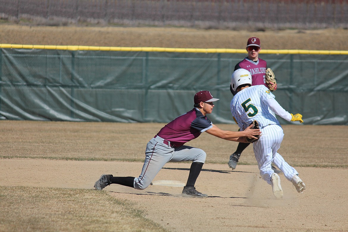 Quincy’s Martin Aguila (5) is tagged out at second.