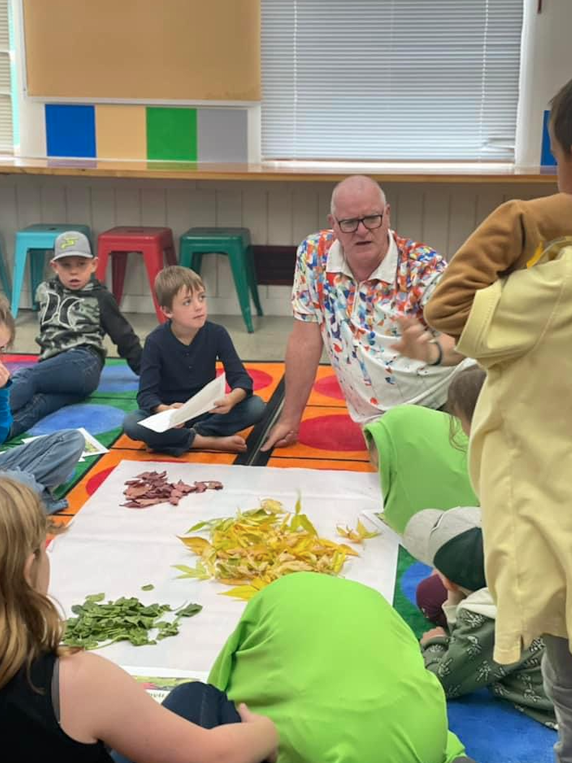 Retired high school science teacher Nick Hoffman explains to students about chlorophyll and why leaves change color in the fall.