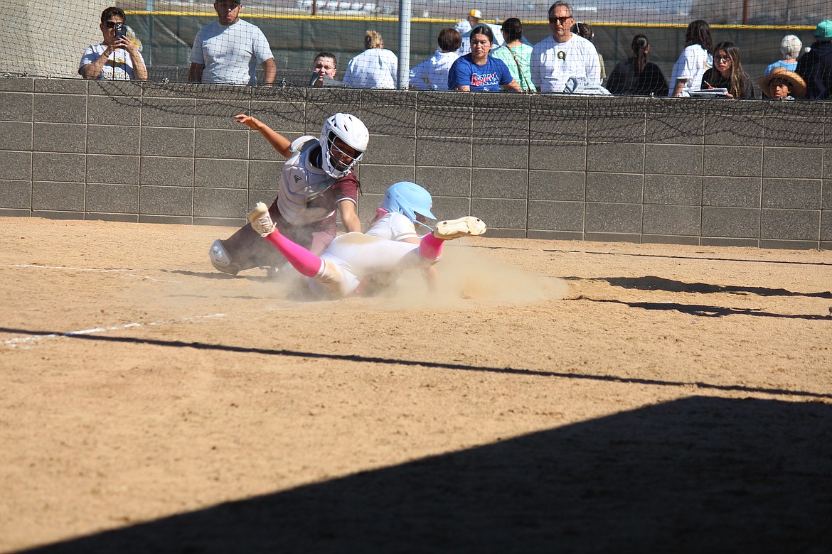 Quincy’s Hayden Morris slides under the tag to steal home in the Jacks’ 9-8 win over Wahluke Saturday.