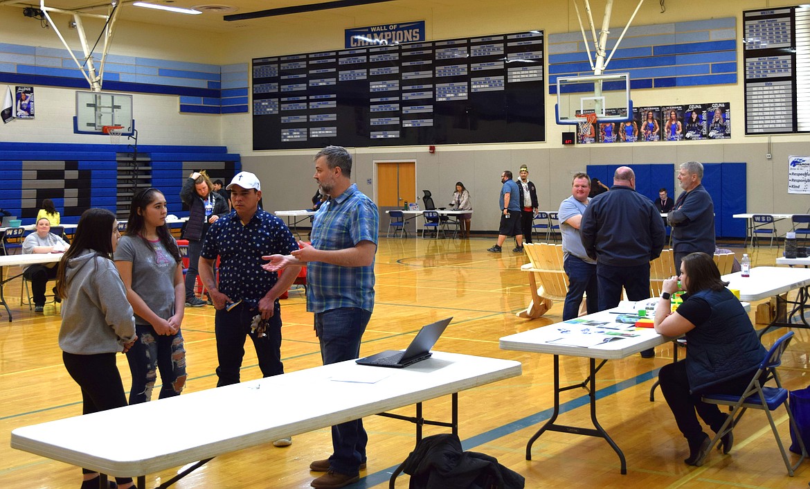 STEM professionals and Warden School District students converse and network during the first Post-Secondary STEM Day fair Thursday evening in the Warden High School gym. STEM professionals visited the school to hear students’ presentations on different career paths before sharing with the students about their own experiences.