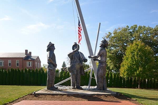 This statue is entitled "To Lift a Nation" and was created by Stan Watts at the National Memorial Park in Falls Church, Virg. Washington legislators passed a law this year that will establish a firefighters' memorial for the state that will be housed in Olympia on the Capitol Campus.