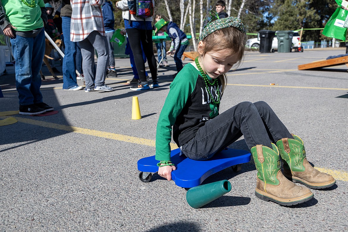 Four-year-old Freya scooches around the cones at the Kids Carnival for Cloverfest Saturday, March 16. (Avery Howe photo)