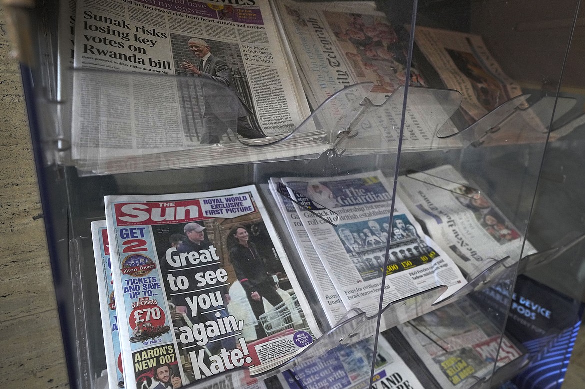 Newspapers on display for sale in London, Tuesday, March 19, 2024. A British newspaper says Prince William and his wife Catherine have been filmed at a farm shop near their Windsor home. It's the first reported footage of Kate since she had abdominal surgery for an unspecified condition two months ago. The Sun published a short clip late Monday that appeared to show the couple smiling as they walked together, carrying shopping bags. It said the footage was taken on Saturday. (AP Photo/Kirsty Wigglesworth)