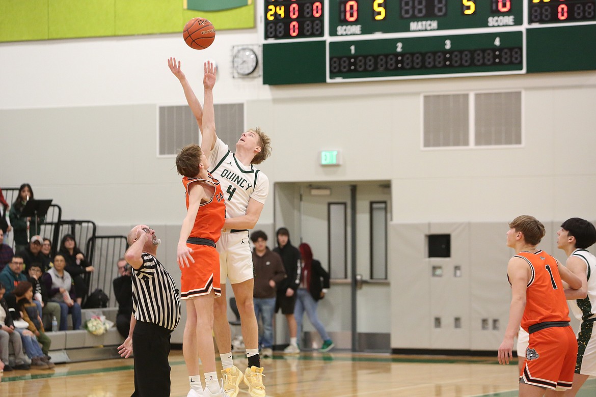 Quincy senior Aidan Bews (4) leaps up for the opening tip-off to open a game against Cashmere this season. Bews played on the 1A all-state team last weekend.