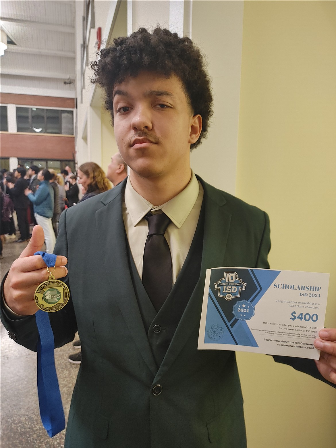 Moses Lake High School senior Brock Smith shows off his 4A state championship ribbon and award from the state speech competition.