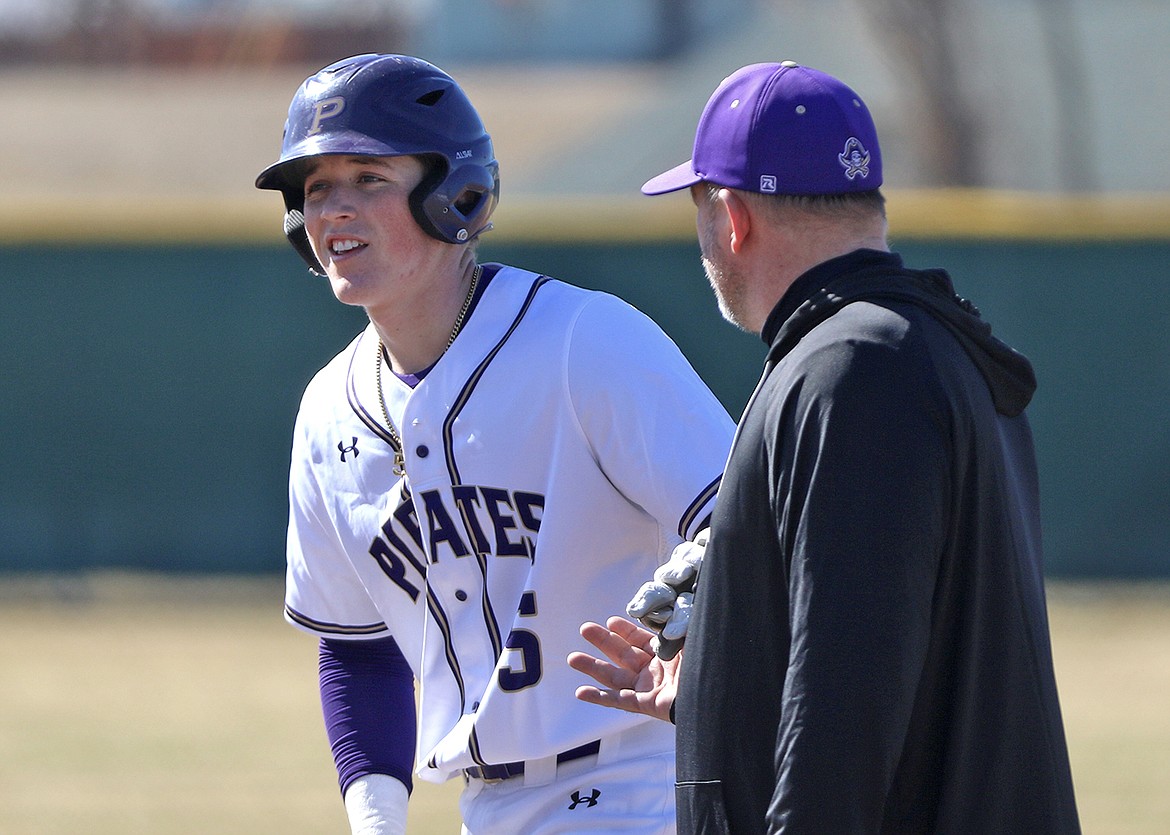 Coach Brad Fisher talks to son Espn on first base. (Bob Gunderson photo)