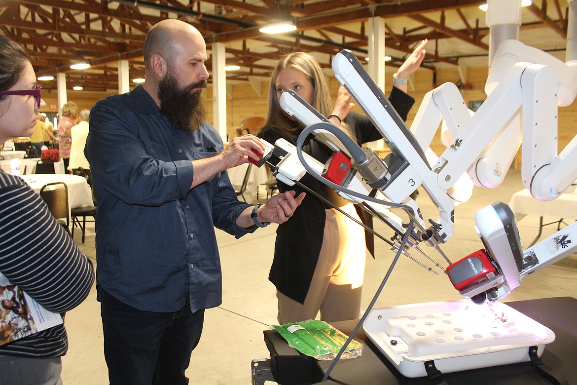 Adrian Palacio removes a tool module from the da Vinci medical robot.