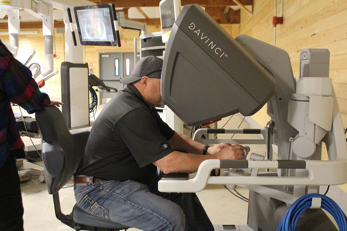 Doug Robins tries his hand at robotic manipulation with the demonstration da Vinci robot.