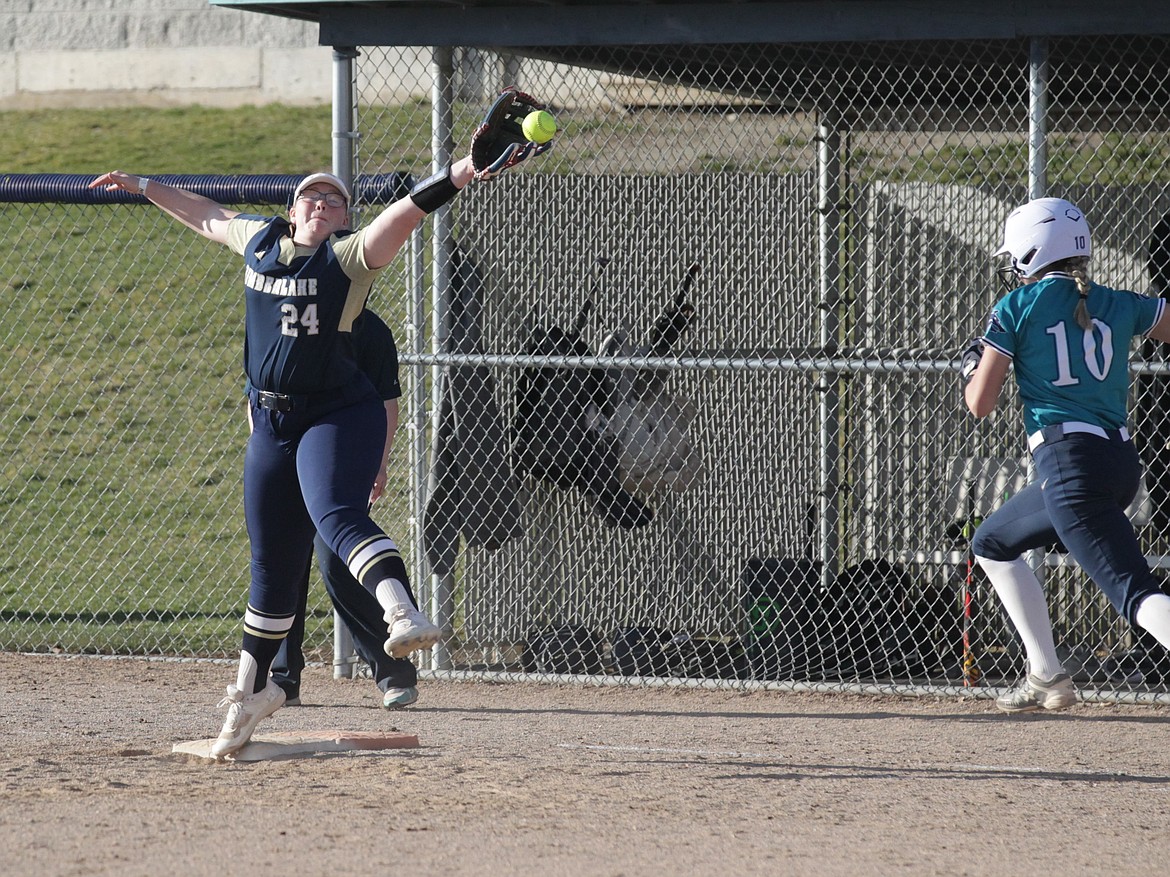 MARK NELKE/Press
Timberlake senior Acacia Pecor (24) stretches to snag the throw to first base, as Layla Gugino (10) of Lake City heads down the line Tuesday at Lake City.