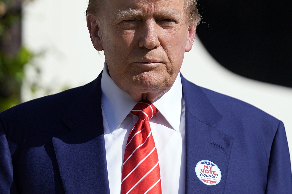 Republican presidential candidate former President Donald Trump listens to a question from a reporter after voting in the Florida primary election in Palm Beach, Fla., Tuesday, March 19, 2024. (AP Photo/Wilfredo Lee)