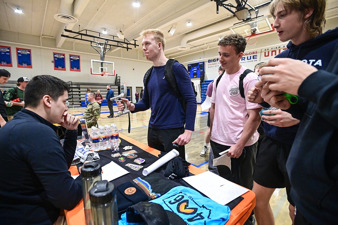 Bigfork High School students test their grip strength with a dynamometer at the OrthoRehab Physical Therapy stand with Caleb Chuang at the Bigfork Job Fair at Bigfork High School on Wednesday, March 20. (Casey Kreider/Daily Inter Lake)