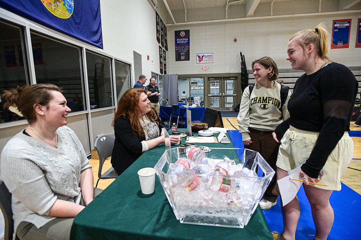 Rose Goossens and Maia Daigle with the Timbers Motel speak with Bigfork High School juniors Lily Bryman and Anna Hocevar at the Bigfork Job Fair at Bigfork High School on Wednesday, March 20. (Casey Kreider/Daily Inter Lake)