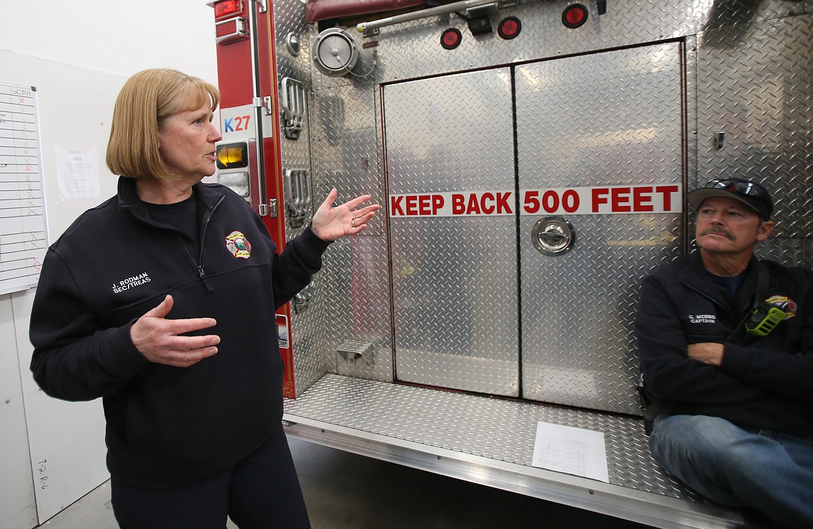 Joan Rodman, Hauser Fire treasurer and administrative assistant, provides details Tuesday about why the volunteer fire department will be floating a $480,675 levy in May. An open house will be from 6-7:30 tonight at the Hauser Fire Station, 10728 N. Hauser Lake Road, for community members to engage with fire officials and ask questions about the upcoming levy election. Also pictured: Hauser Fire Capt. Gary Mobbs.