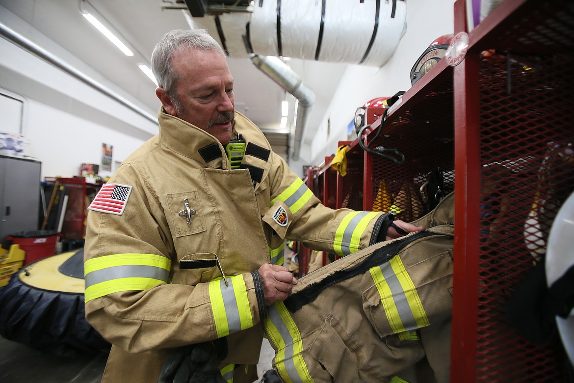 Hauser Fire Capt. Gary Mobbs, who started with the department when he was 18, shows wear and tear on firefighter turnout gear Tuesday at the station.