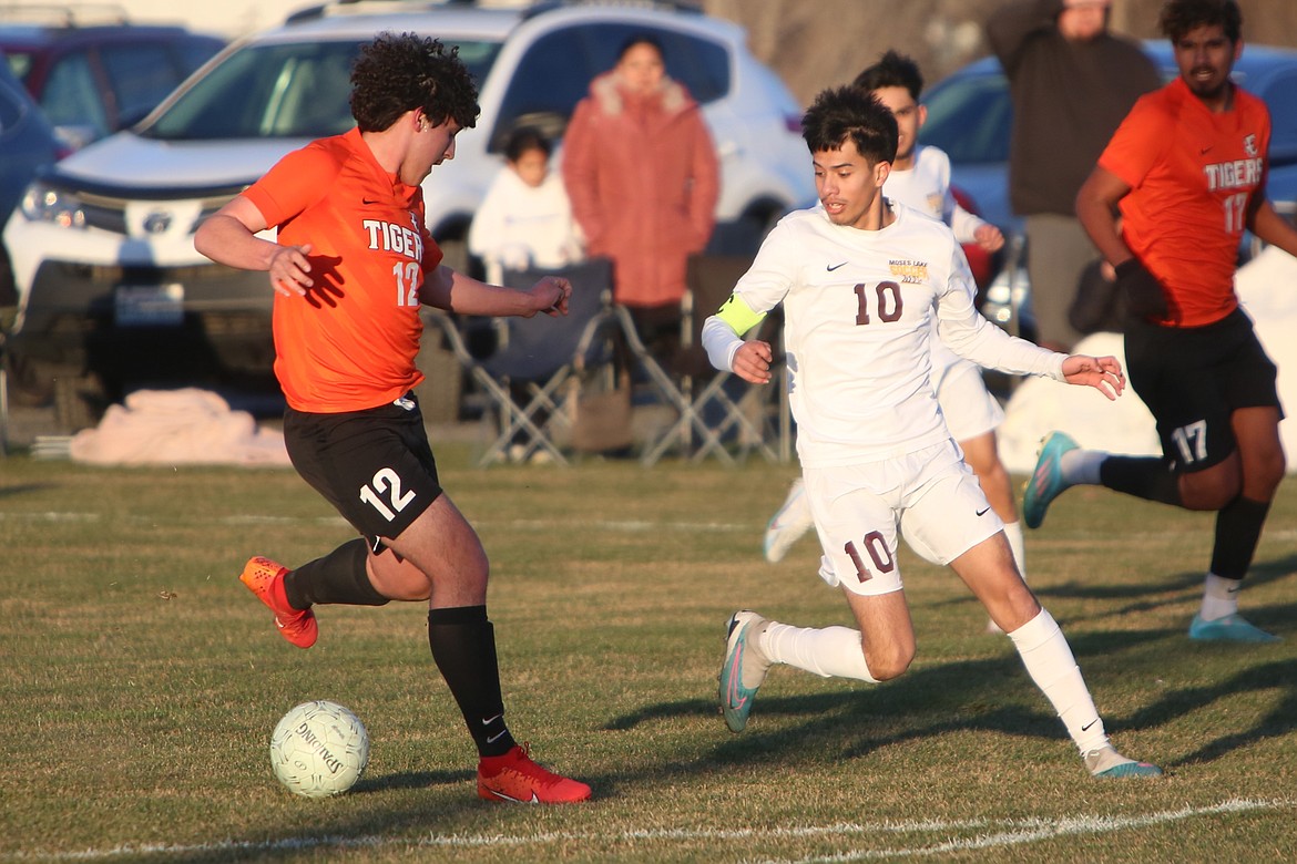 Ephrata junior Jose Negrete Jr. (12) brings the ball upfield while being defended by Moses Lake senior Joshua Zamora (10) during a March 12 game.