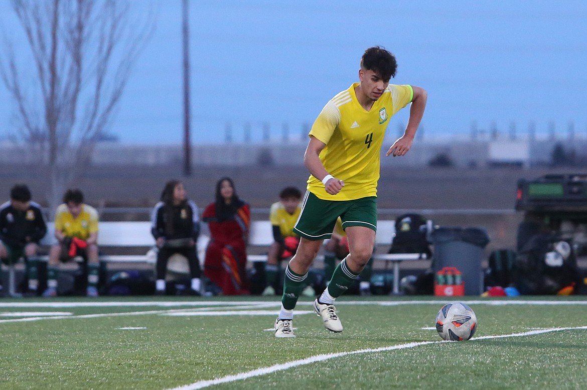 Quincy senior Guillermo Gomez attempts a free kick against Overlake.