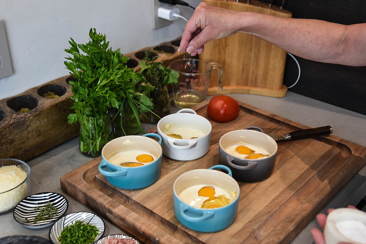 Gina Simmonds, author of "How to Cook Like Mom," adds flavor to an egg dish in her kitchen in Whitefish on March 21, 2024. (Kate Heston/Daily Inter Lake)